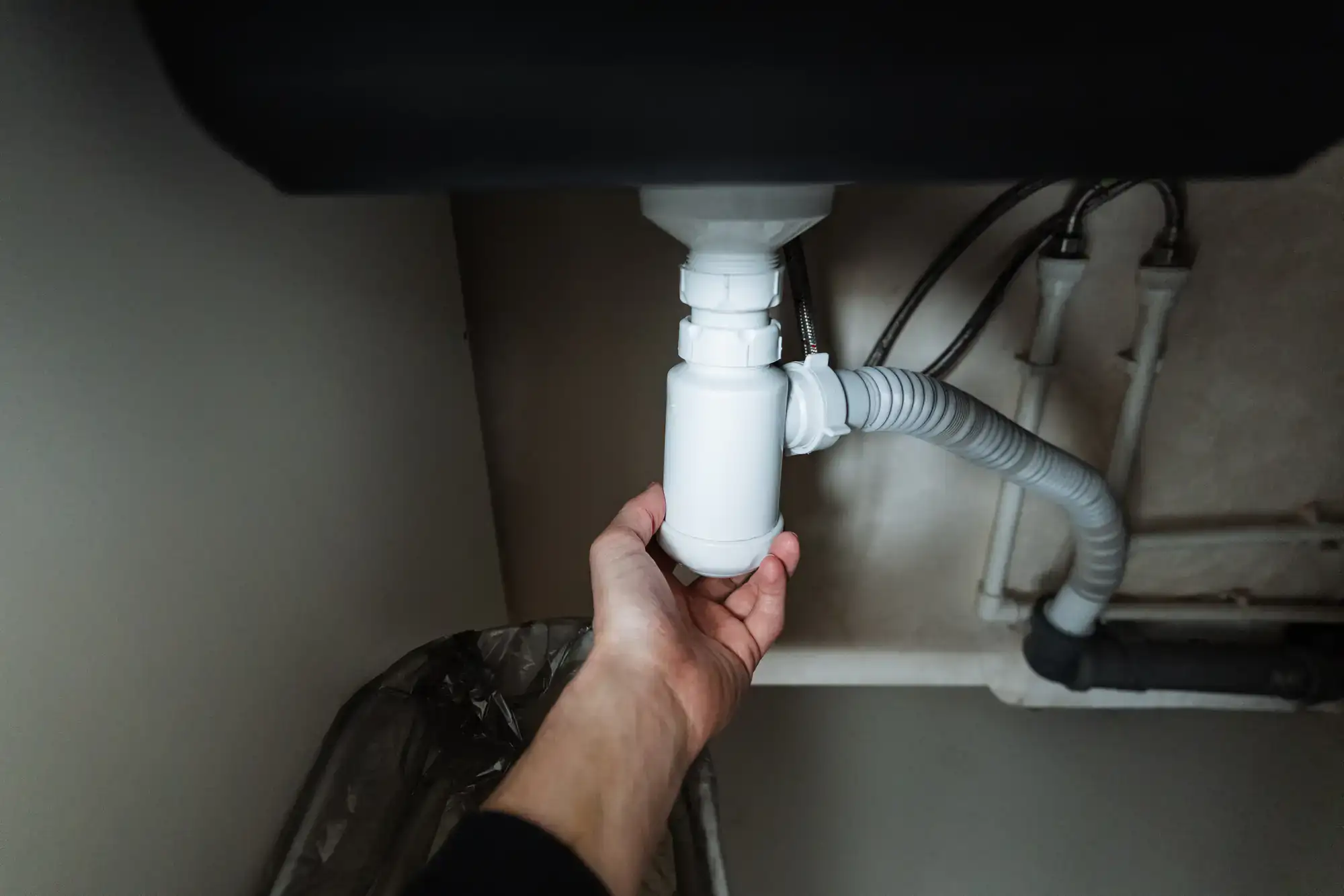 A skilled plumber from Murray Plumbing repairing a pipe by hand in El Dorado County, California, ensuring a durable and efficient fix for the plumbing system