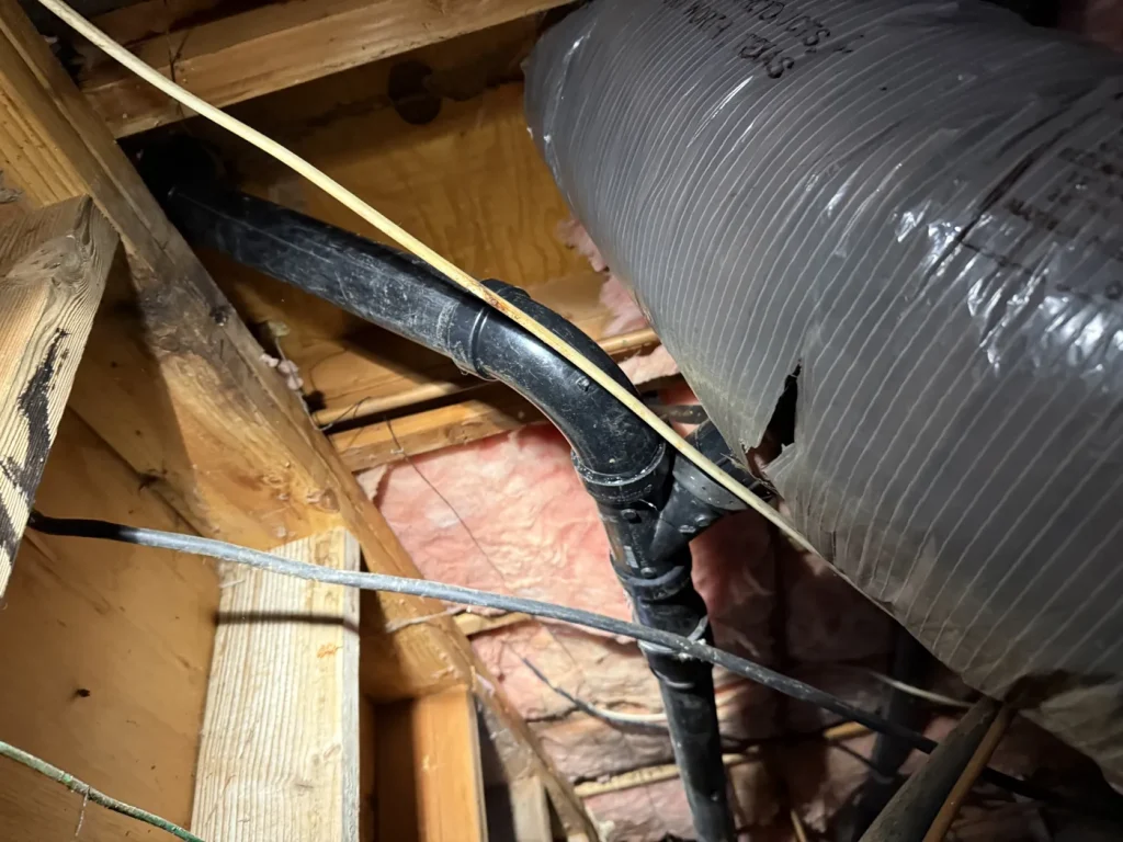 Another view of the accessible drain piping.