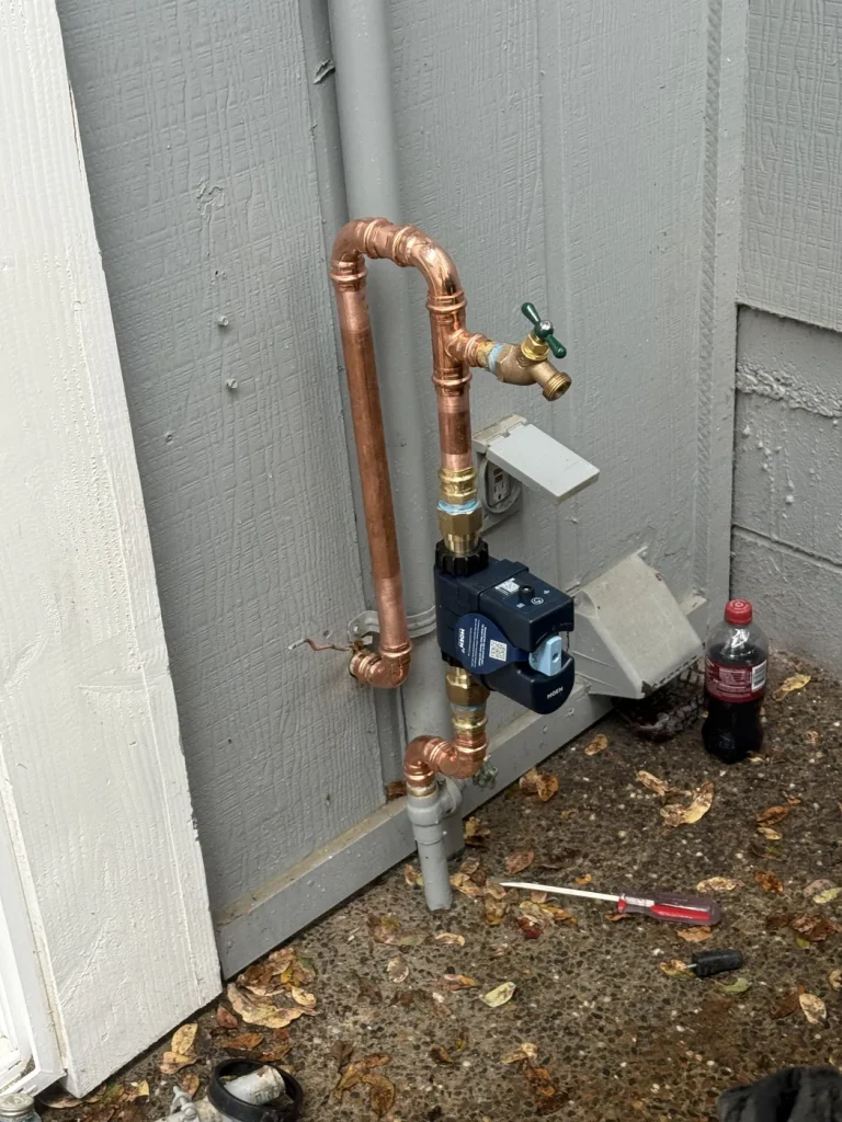 The Moen detector installed on the exterior copper water line.