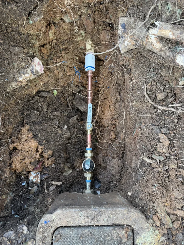 The exposed regulator and water-line connections.
