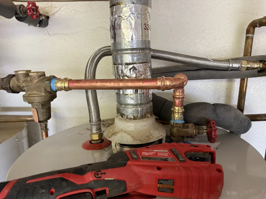 The water heater supply piping in the repair area.