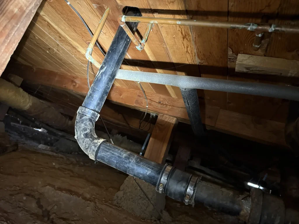 Another view of the exposed drain piping.