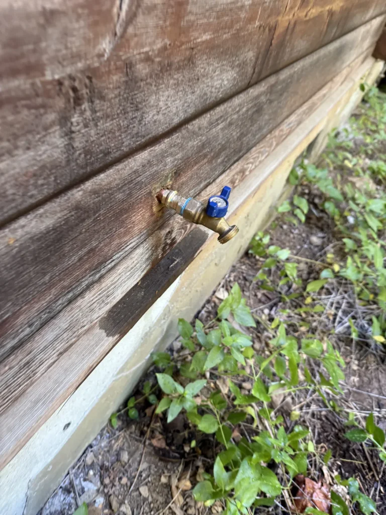 An exterior plumbing connection included in the job photographs.