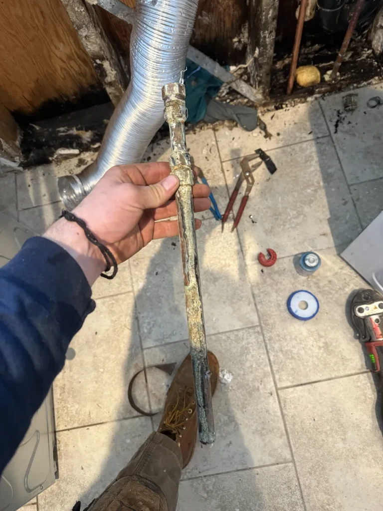 The removed pipe section documented during the repair.