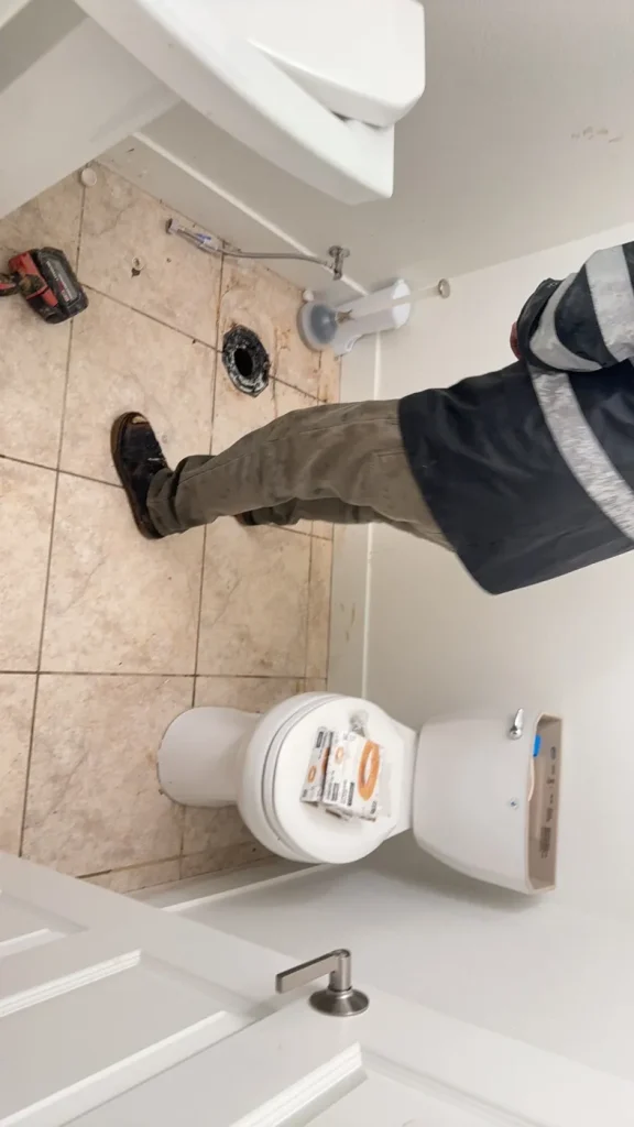 The toilet removed to expose the drain opening for clearing.