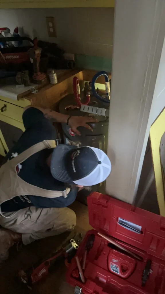 A Murray technician working at the indoor water heater.